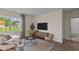 Cozy living area featuring luxury vinyl flooring, a large window, and comfortable seating at 7750 Michelle Rd, Rocky Mount, NC 27803