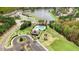 Aerial view highlighting community pool, playground, clubhouse, and a picturesque lake, creating an inviting residential atmosphere at 825 Golden Plum Ln, Zebulon, NC 27597
