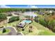 Community aerial view showcasing a pool, playground, lake, and well-maintained landscaping at 825 Golden Plum Ln, Zebulon, NC 27597