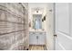 Clean bathroom with vanity sink, decorative mirror, and a shower with a patterned curtain at 825 Golden Plum Ln, Zebulon, NC 27597