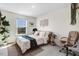 Inviting bedroom with neutral tones, a comfortable bed, and a cozy reading corner at 825 Golden Plum Ln, Zebulon, NC 27597