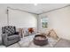 Cozy ' bedroom with playful decor, a crib, and a comfortable armchair at 825 Golden Plum Ln, Zebulon, NC 27597