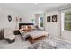 Cozy bedroom featuring natural light, neutral carpet, and stylish décor at 825 Golden Plum Ln, Zebulon, NC 27597