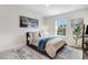 Stylish bedroom with a large painting, a comfortable bed, and a view from the window at 825 Golden Plum Ln, Zebulon, NC 27597