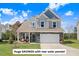 Charming two-story home with stone accents, well-manicured lawn, and an attached two-car garage at 825 Golden Plum Ln, Zebulon, NC 27597