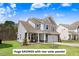 Charming two-story home with a well-manicured lawn and inviting front porch at 825 Golden Plum Ln, Zebulon, NC 27597