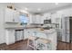 Bright kitchen with granite countertops, stainless steel appliances and a breakfast bar with seating at 825 Golden Plum Ln, Zebulon, NC 27597
