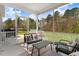 Inviting screened-in porch with comfortable seating, offering a perfect blend of indoor-outdoor living overlooking the backyard at 825 Golden Plum Ln, Zebulon, NC 27597