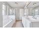 Bathroom featuring a glass enclosed shower, garden tub, and double vanity at 8641 Neuse Club Ln # 110, Raleigh, NC 27616