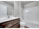 Bright bathroom with a modern vanity, white toilet, and a bathtub with shower at 8641 Neuse Club Ln # 110, Raleigh, NC 27616