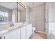 Bright bathroom with double vanity, large mirror, and neutral-toned flooring at 8641 Neuse Club Ln # 110, Raleigh, NC 27616