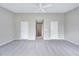 Large bedroom with gray walls and neutral carpeting at 8641 Neuse Club Ln # 110, Raleigh, NC 27616