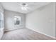 Comfortable bedroom featuring plush carpeting, a ceiling fan, and a bright window at 8641 Neuse Club Ln # 110, Raleigh, NC 27616