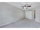 Bright bedroom with neutral carpet, ceiling fan, and double door closet at 8641 Neuse Club Ln # 110, Raleigh, NC 27616