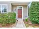 Front entrance features a solid door, manicured shrubs, and a welcoming pathway at 8641 Neuse Club Ln # 110, Raleigh, NC 27616