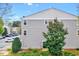 Exterior angle of townhome with vinyl siding and manicured landscaping at 8641 Neuse Club Ln # 110, Raleigh, NC 27616
