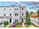 Inviting townhome with neutral siding, blooming azaleas, and a charming red front door at 8641 Neuse Club Ln # 110, Raleigh, NC 27616
