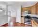 Kitchen featuring stainless steel appliances, wood floors and cabinetry, and black granite countertops at 8641 Neuse Club Ln # 110, Raleigh, NC 27616