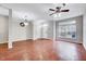 Open living room with hardwood floors, ceiling fan and natural light at 8641 Neuse Club Ln # 110, Raleigh, NC 27616