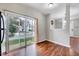 Open concept living room with wood flooring and a glass sliding door providing natural light at 8641 Neuse Club Ln # 110, Raleigh, NC 27616
