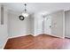 Open living space with beautiful hardwood floors, creating a seamless flow to the dining area at 8641 Neuse Club Ln # 110, Raleigh, NC 27616