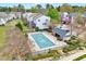 View of a community pool with surrounding landscaping and building at 8641 Neuse Club Ln # 110, Raleigh, NC 27616