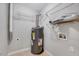 Utility room with water heater, shelving, and washer/dryer hookups for convenience at 8641 Neuse Club Ln # 110, Raleigh, NC 27616