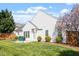 Inviting backyard with patio seating, grill, lush lawn, and flowering trees at 8701 Neuse Village Ct, Raleigh, NC 27616
