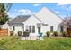 Beautiful backyard with patio, seating, grill, and view of the house's rear exterior at 8701 Neuse Village Ct, Raleigh, NC 27616