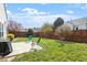 Serene backyard featuring a patio area, chairs, grill, green grass, and a wooden fence at 8701 Neuse Village Ct, Raleigh, NC 27616