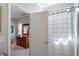 Bathroom area featuring an open door to bedroom area and shower curtain at 8701 Neuse Village Ct, Raleigh, NC 27616