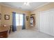 Neutral bedroom featuring a chair, window with curtains, and a closet at 8701 Neuse Village Ct, Raleigh, NC 27616