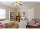 Cozy bedroom featuring a bookshelf, dresser, and a bed with a floral comforter at 8701 Neuse Village Ct, Raleigh, NC 27616