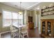 Bright dining area with a wooden table, natural light, hardwood floors and stylish decor at 8701 Neuse Village Ct, Raleigh, NC 27616