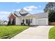 Well maintained home with a paved driveway, manicured lawn and brick and siding facade at 8701 Neuse Village Ct, Raleigh, NC 27616