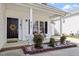 Close up of the home's porch with welcoming decorations and nice landscaping at 8701 Neuse Village Ct, Raleigh, NC 27616