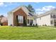 Home's manicured lawn and landscaping, enhanced by a brick accent and a home to the right at 8701 Neuse Village Ct, Raleigh, NC 27616