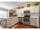 Well-lit kitchen featuring stainless steel appliances, and ample counter space at 8701 Neuse Village Ct, Raleigh, NC 27616