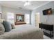 Serene bedroom featuring ample natural light and a dresser with a large mirror at 8701 Neuse Village Ct, Raleigh, NC 27616