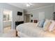 Comfortable bedroom with a ceiling fan, TV, dresser, and a door that goes to the bathroom at 8701 Neuse Village Ct, Raleigh, NC 27616