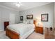 Charming bedroom showcasing a bed with decorative pillows and bedside table with lamp at 8701 Neuse Village Ct, Raleigh, NC 27616