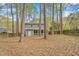 Wooded backyard featuring a screened-in porch, offering a private and peaceful outdoor space at 1010 Flanders St, Garner, NC 27529