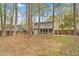 Exterior view of the back of the house with screened-in porch and wooded area, ideal for privacy at 1010 Flanders St, Garner, NC 27529