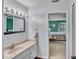 View of a bathroom with a sink and mirror next to a bedroom at 1010 Flanders St, Garner, NC 27529