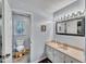 Well-lit bathroom featuring a toilet, vanity, and a shower at 1010 Flanders St, Garner, NC 27529