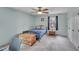 Bright bedroom with blue walls, a ceiling fan, and a bed with a wooden chest at 1010 Flanders St, Garner, NC 27529