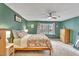 This charming bedroom features a large bed, ceiling fan, and lots of natural light at 1010 Flanders St, Garner, NC 27529
