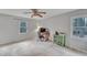 Bright bedroom with ample natural light, featuring neutral carpeting and a ceiling fan at 1010 Flanders St, Garner, NC 27529