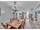 Dining room featuring french doors, modern chandelier, and kitchen access for easy entertaining at 1010 Flanders St, Garner, NC 27529