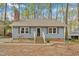 Charming blue house with a welcoming front and picturesque landscaping, creating a cozy curb appeal at 1010 Flanders St, Garner, NC 27529